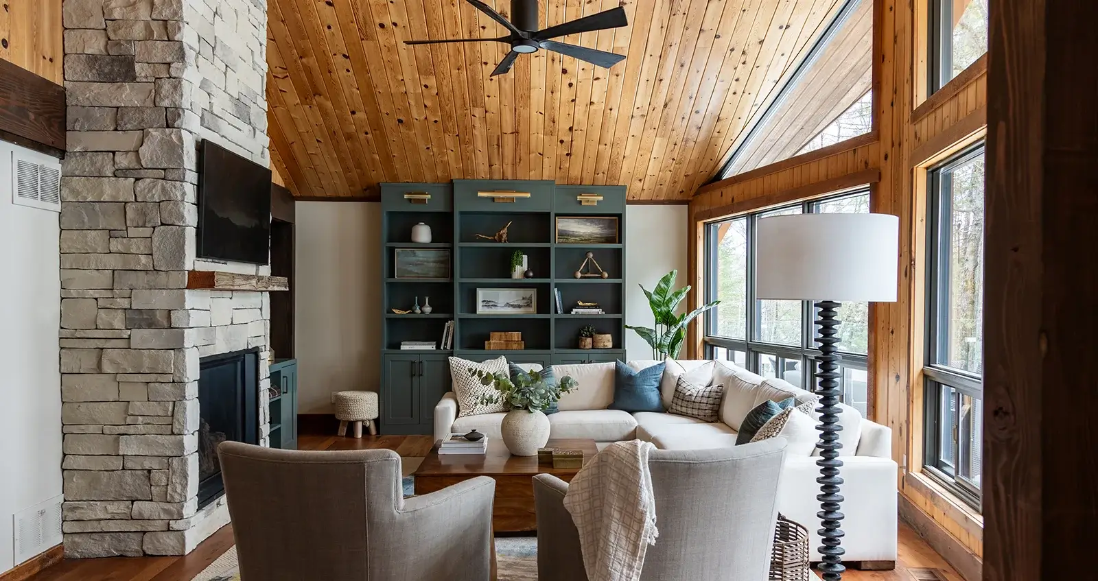 Rustic mountain home interior living room featuring timber beams, stone fireplace, and custom craftsmanship in Sun Valley, Idaho